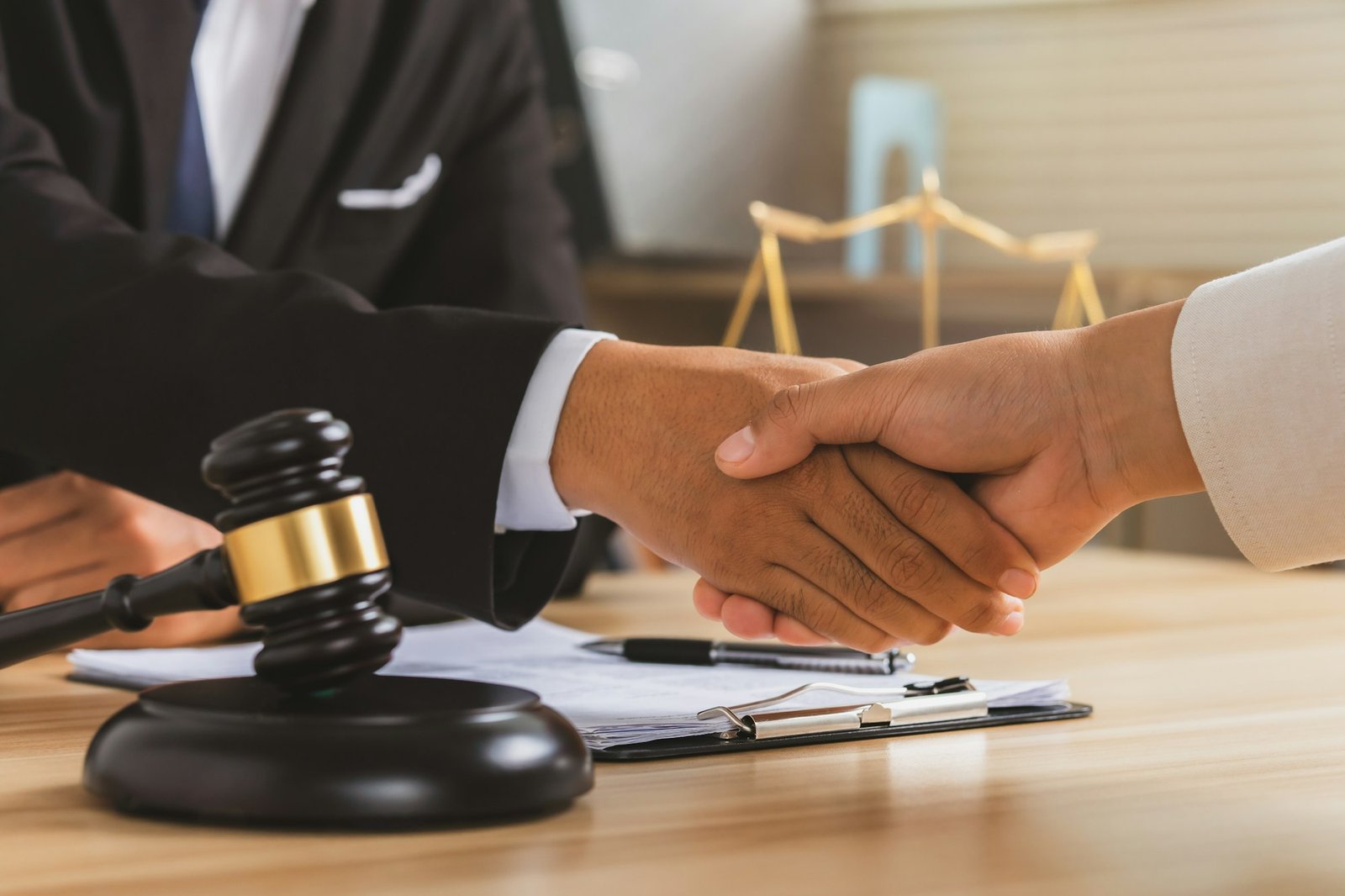 justice and law concept.Legal law, advice and justice, Businessman handshake with a lawyer.